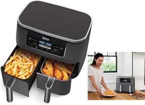 Ninja air fryer with baskets open holding fries and potato wedges next to woman holding plate of fries